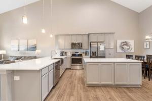 a kitchen with white cabinets and a white counter top at The Lakeview Penthouse - 10ppl in Branson +16 photos