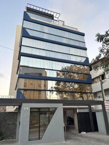 a tall glass building with a building at Azzure Apartmento 103 Intermares in Cabedelo