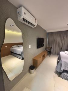 a hotel room with two beds and a tv at Azzure Apartmento 103 Intermares in Cabedelo +8 photos