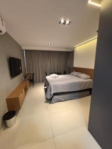 a hotel room with a bed and a desk at Azzure Apartmento 103 Intermares in Cabedelo