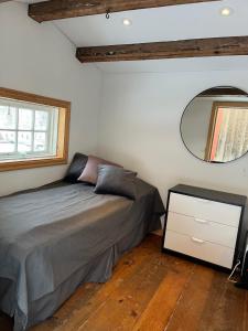 a bedroom with a bed and a mirror at Cozy cabin with an amazing view in Åre