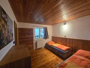 a bedroom with two beds and a wooden ceiling at Apartmány Lebedín in Nová Ves