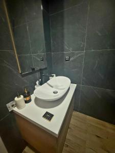 a bathroom with a white sink on a counter at N-LUX 66 MILMARI kopaonik in Kopaonik +14 photos
