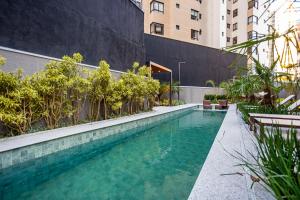 a swimming pool in the middle of a building at My Place in Curitiba