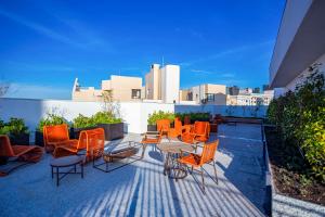 a group of chairs and tables on a patio at My Place in Curitiba