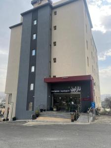 a large building with a store in front of it at شقق نازلين للشقق المخدومة in Al Bahadah