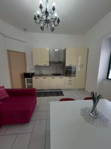 a living room with a red couch and a table at A casa di Rita in Agropoli