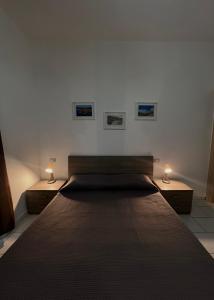 a bedroom with a large bed with two night stands at A casa di Rita in Agropoli