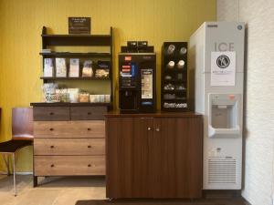 a coffee shop with a vending machine next to a dresser at Hotel Reference Tenjin - Vacation STAY 80083v in Susakiuramachi