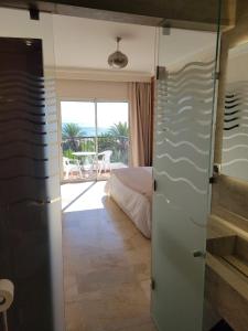 a room with a bedroom with a bed and a balcony at marina1 in Agadir