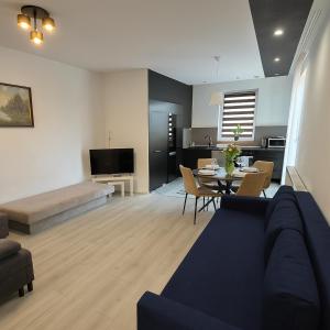 a living room with a couch and a table at TANIE NOCLEGOWANIE in Katowice