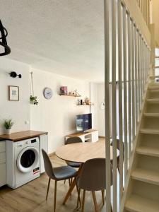 a kitchen and dining room with a table and chairs at Mazet Golfe de Saint-Tropez in Cogolin +5 photos