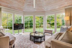 a living room with a couch and a tv at Thatched country escape - Aarhus in Lystrup