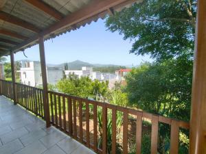 a balcony with a view of the city at Casa de vó do interior, cidade do Cristo Protetor in Encantado