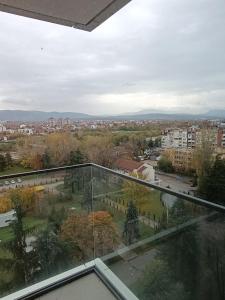 a view of a city from a glass balcony at Planet Green Residence in Niš +24 photos