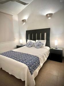 a bedroom with a large bed with two pillows at Casa Romantica De Playa in Ixtapa
