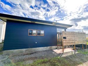 a blue building with windows on the side of it at NOA - Vacation STAY 80085v in Shikyū