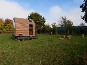 a small wooden cabin in a field of grass at Políčko in České Budějovice