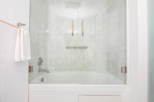 a white bathroom with a tub and a shower at Girasole Suites in Miami Beach +29 photos