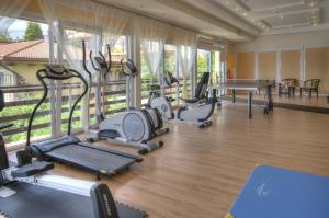 a gym with treadmills and exercise equipment in a room at Panoramic-Oscar in Mrągowo