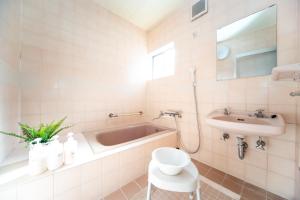 a bathroom with a bath tub and a sink at Awaji Centaral Villa in Shizuki - Vacation STAY 81902v in Shizuki +51 photos