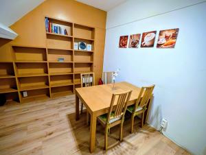 a dining room with a table and chairs and shelves at Duplex 3BR apartment near supermarkets & metro in Brussels +6 photos