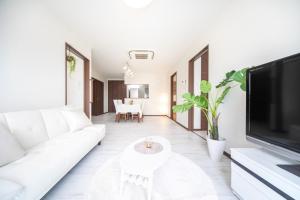 a living room with a white couch and a tv at Awaji Riverside Terrace in Shizuki - Vacation STAY 81986v in Shizuki