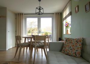 a living room with a table and chairs and a couch at Casa Del Faro in Westkapelle +14 photos