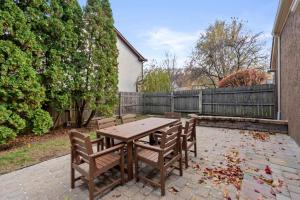 a wooden table and chairs on a patio at Dublin Blue Haven - Home for 12 in Dublin