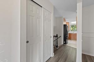 a hallway with a white door and a kitchen at Dublin Blue Haven - Home for 12 in Dublin +40 photos