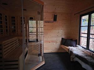 a room with a glass shower in a wooden cabin at Baranja Black Hill's in Gajić