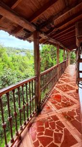 a balcony of a house with a view of the forest at Finca 5 Continentes - Cerca MatroCable ARVI in Guarne