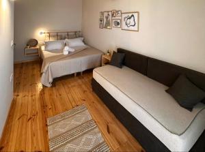 a small bedroom with two beds and a couch at Athina's Cozy Guest House in Kamisianá