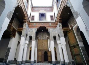 an entrance to a mosque with a wooden door at Dar Seffarine in Fez +39 photos