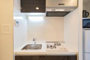 a kitchen with a sink and a counter top at Ruygo Setagaya 201 - Vacation STAY 83644v in Tokyo +18 photos