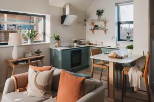 a kitchen with a couch and a table in a room at Adam in Newent