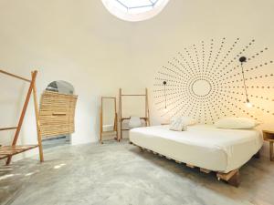 a bedroom with a bed and a large mandala on the wall at Nowhere in Bocas Town
