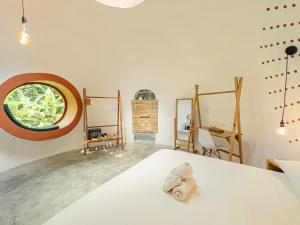 a bedroom with a bed and a round window at Nowhere in Bocas Town