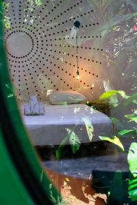 a bedroom with a bed and a fishtank at Nowhere in Bocas Town +32 photos