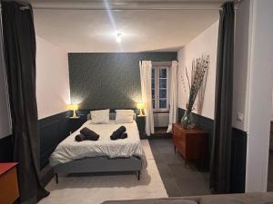 a bedroom with a bed with two pillows on it at L'Albuconis 1 Grand Studio in Aubusson