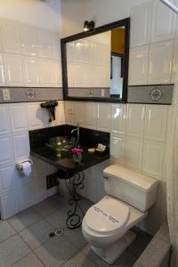 a bathroom with a toilet and a sink and a mirror at Tika Wasi Casa Boutique in Cusco