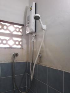 a shower head in a bathroom with a window at Palm Point Village in Mae Nam
