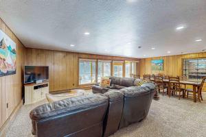 a living room with a couch and a dining room at Rainbow Riverhouse in South Fork