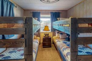 a bedroom with two bunk beds and a window at Rainbow Riverhouse in South Fork