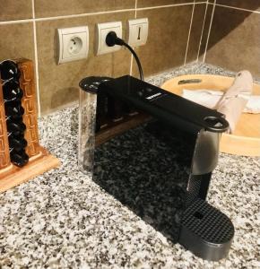 a black brush sitting on top of a bathroom counter at Tipanie- Great 1bedroom in PPT, AC w pool & open view in Papeete