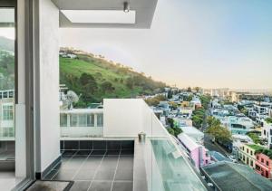 a view of a city from the balcony of a building at Luxury 2BR Sky Suite City Views & Prime Location in Cape Town