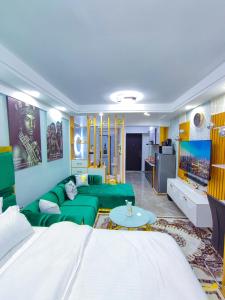 a living room with a green couch and a tv at Tsavo in Nairobi