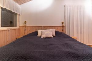 a bedroom with a large bed and a window at Arctic Escape Near Santa Claus Village in Rovaniemi +8 photos