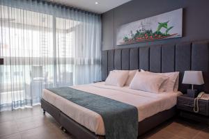 a bedroom with a large bed and a large window at Tres habitaciones - Vista al Mar in Cartagena de Indias +47 photos