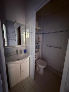 a white bathroom with a sink and a toilet at Sea View in Quend-Plage +19 photos